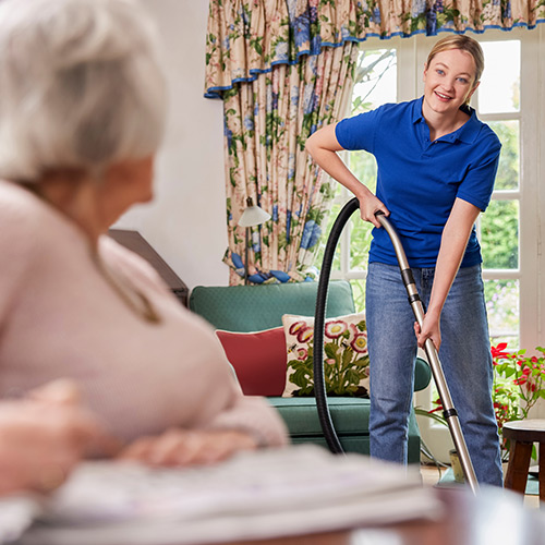 woman vacuuming in retirement home